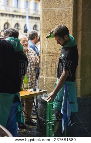 San Sebastian, Spain - September 2, 2017. Waitress Serving Cider During Sagardo Eguna (cider Day) In