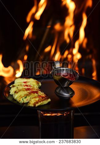 Delicious Cheesy Dish Served In Restaurant On Black Dishes. Dish Of Grilled Cheese Served With Raspb