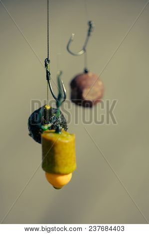 Fishhooks On Line On Blurred Background. Hooks With Fishing Bait, Chumming. Fishing, Angling, Catchi