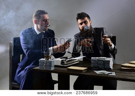 Company Engaged In Illegal Business. Men Sitting At Table With Piles Of Money And Typewriter. Busine