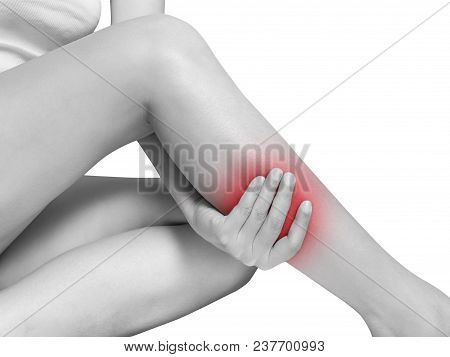 Woman Suffering From Leg Pain, Calf Pain. Mono Tone Highlight At Calf, Leg Isolated On White Backgro