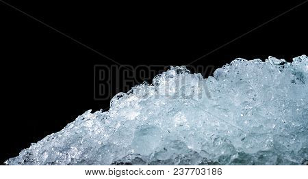 Pile Of Crushed Ice Cubes On Dark Background With Copy Space. Crushed Ice Cubes Foreground For Bever