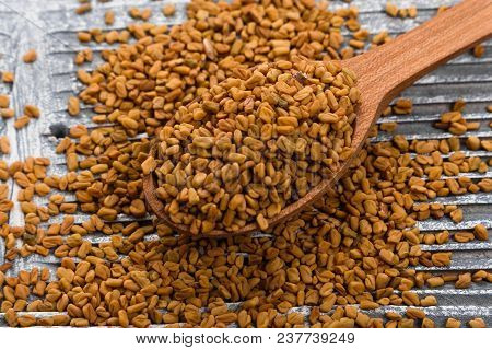 Fragrant Grains Of Fenugreek On A Rustic Background.