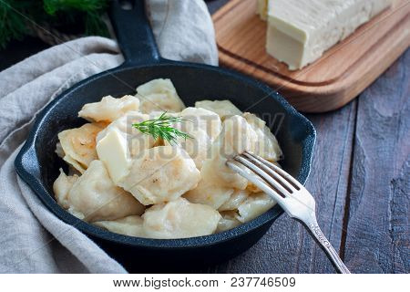 Fried Dumplings With Cabbage In A Portioned Cast-iron Frying Pan, Selective Focus