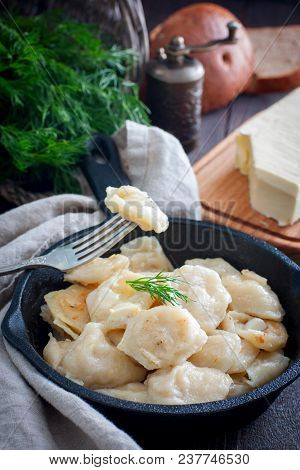 Fried Dumplings With Cabbage In A Portioned Cast-iron Frying Pan, Selective Focus
