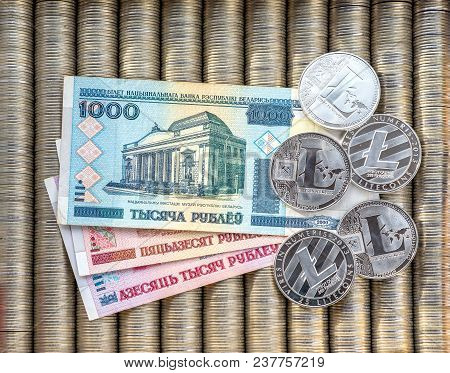 Silver Crypto Coins Litecoin Ltc, Paper Denominations Belarusian Ruble. Metal Coins Are Laid Out In 