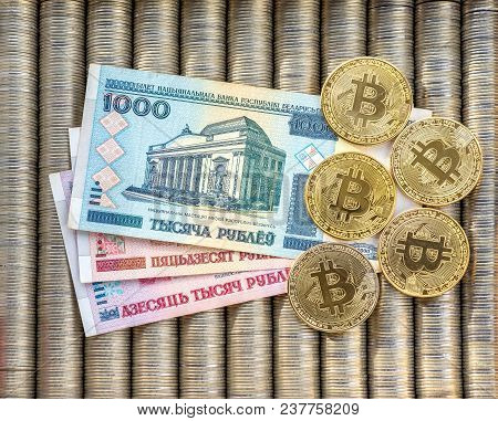 Gold Crypto Coins Bitcoin Btc, Paper Belarusian Ruble. Metal Coins Are Laid Out In A Flat Background