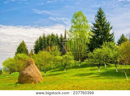 Scenic Spring Rural Landscape With Traditional Maramures Neo-gothic Wooden Church On Background And 