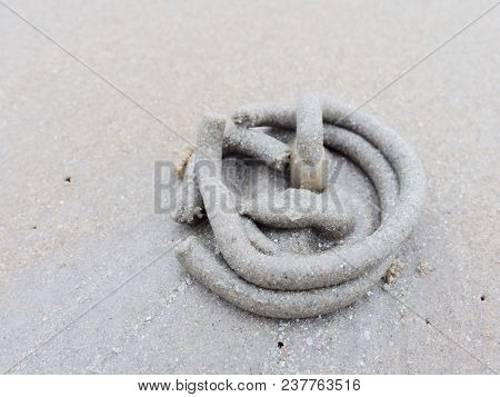 Abstract Shape Of Swirl Of Sand And Mud On The Beach Cast By Lug Or Sand Worms With Sediment Balls O