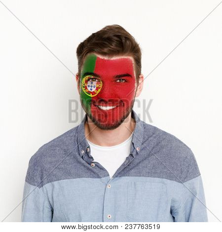 Face Of Young Happy Man Painted With Flag Of Portugal. Football Or Soccer Team Fan, Sport Event, Fac