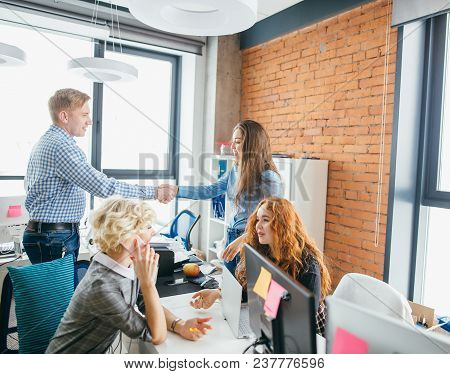 Man Is Agree To Cooperate As A Volunteer. Guy Is Shaking Hands With Young Pretty Woman While Red-hai