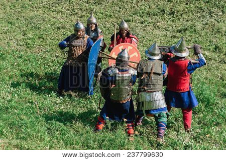 Luh, Russia - August 27, 2016: Reconstruction Of Medieval Battle Of Knights In Armor And Weapons At 