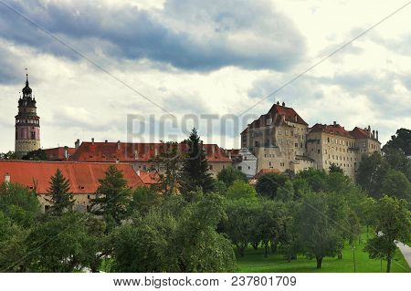 Cesky Krumlov Castle At Dusk With Trees And Cloudy Sky, Unesco Town, Czech Republic.