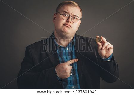 Fat Man Pointing At Golden Bitcoin In Hand, Digitall Symbol Of New Virtual Currency