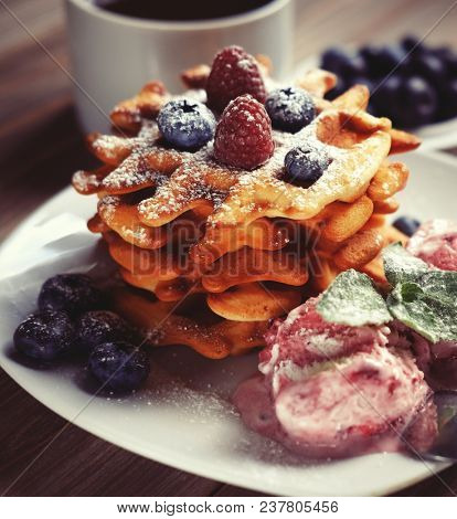 Belgian waffles with fresh berries and ice cream close up
