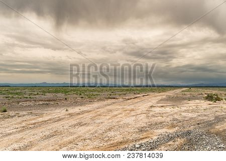 Scenic View On Very Long Road Till Horizon. Boundless Kazakh Steppes. Dramatic Sky And Clouds. Mount