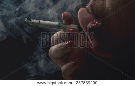 Woman With Red Nail Is Smoking Cigarette On Dark Background. Quit Smoking Concept. Bad Habit In Woma