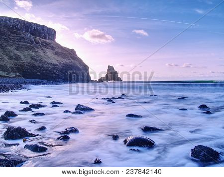Tranquil Stony Bay In Scotland After Sunset.  Slow Shutter Speed For Smooth Water Level And Dreamy E