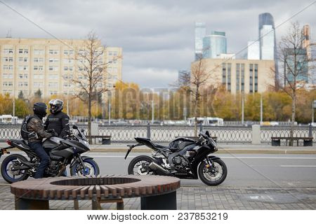 MOSCOW, RUSSIA - OCT 19, 2017: Two men with motorcicles Yamaha Diversion and Honda Fireblade at Moscow river embankment.