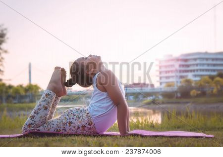 Healthy Yoga Girls And Concentrate In The Park , Kid Yoga Practice For Health In The Nice Day , Yoga