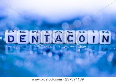 Word Dentacoin Formed By Alphabet Blocks On Mother Cryptocurrency Closeup