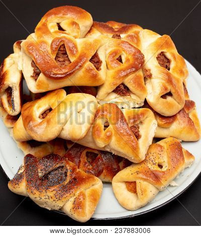 Buns With Raisins And Jam On A Black Background .