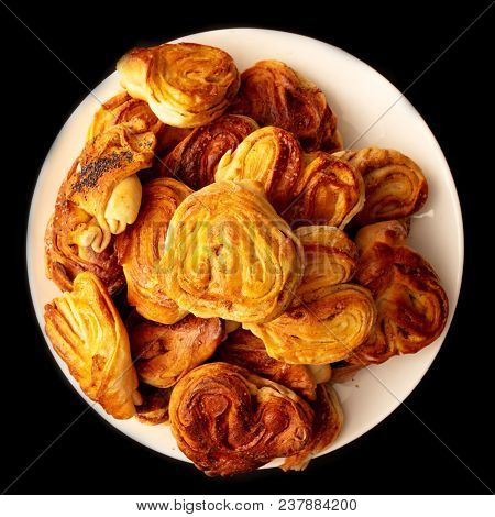 Buns With Raisins And Jam On A Black Background .