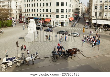 Vienna, Austria - 15 April 2018: A Cab Driver In A Carriage With Two Horses Drives Tourists Around T