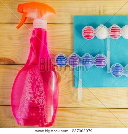 Cleaning House Or Office Concept. A Blue Rag, Pink Cleaning Spary And Toilet Refreshing Blocks On Na