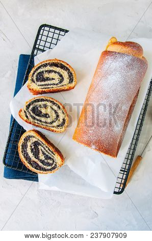 Traditional Polish Festive Pastry - Makowiec- Poppy Seed Roll Covered With Powdered Sugar On A  Whit