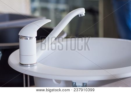 Modern Kitchen And Bathroom Water Faucets In The Store. Selective Focus. There Is Free Space For Tex