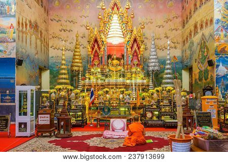 Nongkai, Thailand - December 6, 2015: Buddhist Monk Meditating In Front Of Golden Buddha Image In Be
