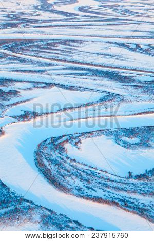 Aerial View Above The Snow Covered Tundra River In Time Of Short Winter Day.