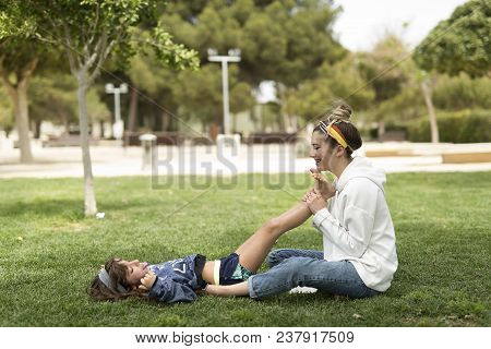 Sisters Playing Happily In A Park.