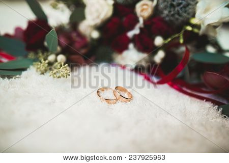 Two Golden Wedding Rings Isolated Background Concept.