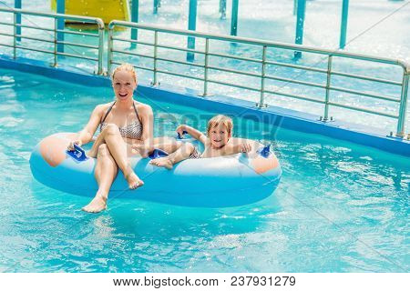 Mom And Son Have Fun At The Water Park.