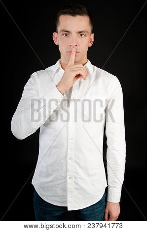 Keep Silence. Attractive Guy. Shhhh. Man Was Silent. Black Background.