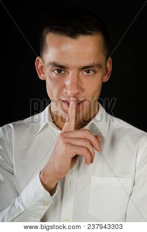 Keep Silence. Attractive Guy. Shhhh. Man Was Silent. Black Background.