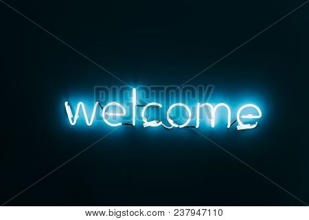 Welcome Neon Sign On Brick Wall Background