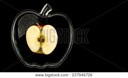 Sliced Apple In A Glass Bowl On A Black Background.