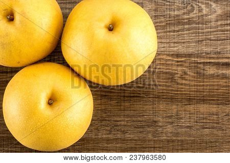Chinese Golden Pears Top View Nashi Variety Isolated On Wooden Background Three Whole Round