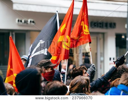 Strasbourg, France  - Mar 22, 2018: Young Communist Flags In Hands At Demonstration Protest Against 