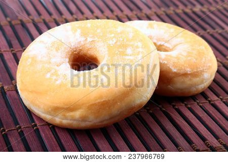 Homemade Doughnuts With Jelly Filled And Powdered Sugar On Bamboo Tablecloth. Selective Focus
