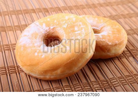 Homemade Doughnuts With Jelly Filled And Powdered Sugar On Bamboo Tablecloth. Selective Focus