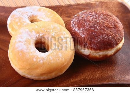 Assorted Homemade Doughnuts With Jelly Filled And Powdered Sugar On Wooden Salver. Selective Focus