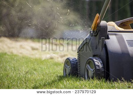 Gardener Operating Soil Aeration Machine On Grass Lawn.