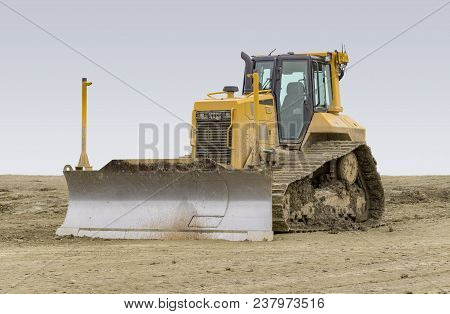 Yellow Bulldozer At A Loamy Construction Site
