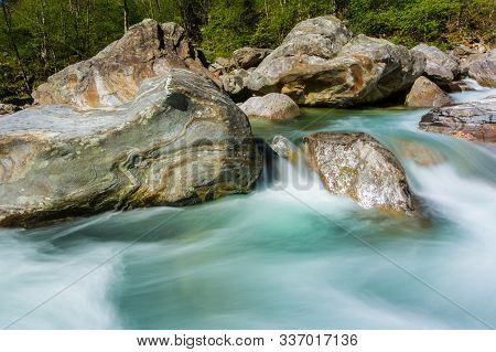 Natural Green Verzasca River Water With Stones In Shunshine