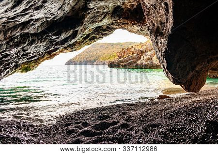 Amazing Seascape View From Unique Sea Cave Overhanging Above Water On Famous Cala Bianca Beach Sceni