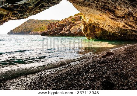 Amazing Seascape View From Unique Sea Cave Overhanging Above Water On Famous Cala Bianca Beach Sceni